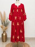 Red floral embroidered maxi dress with scattered pink and yellow flowers and gold dot print